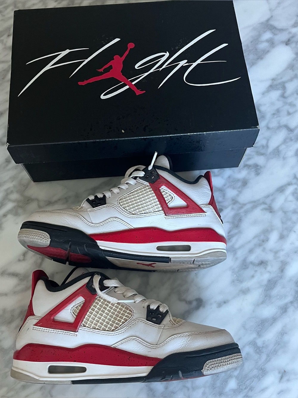 Jordan 4 Retro "Bred" white and red sneakers with black accents #basketball